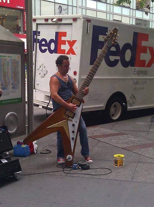 Big guitar street player